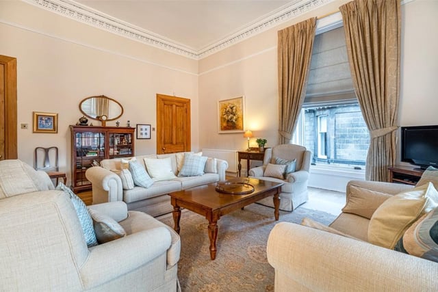 The spacious lounge has a large walk-in storage cupboard.