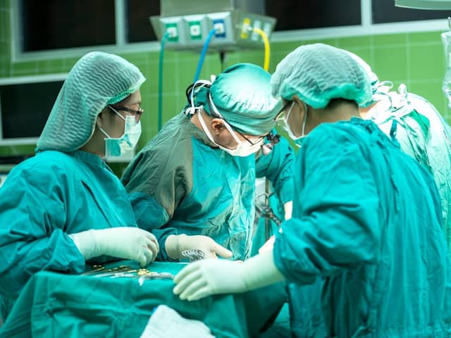 Surgery operation surgeons doctors nurses operating theatre