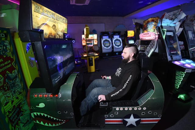 Chris Mowbray playing Blazing Angels - a flight simulator video arcade game