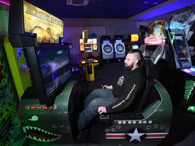 Chris Mowbray playing Blazing Angels - a flight simulator video arcade game