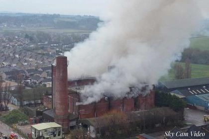 Smoke pours out of a large building on fire in Lancaster.