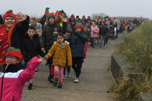 Elves as far as the eye can see! Chaucer Primary School's Elf Run snakes along the coast path at Fleetwood. Photo: Neil Cross