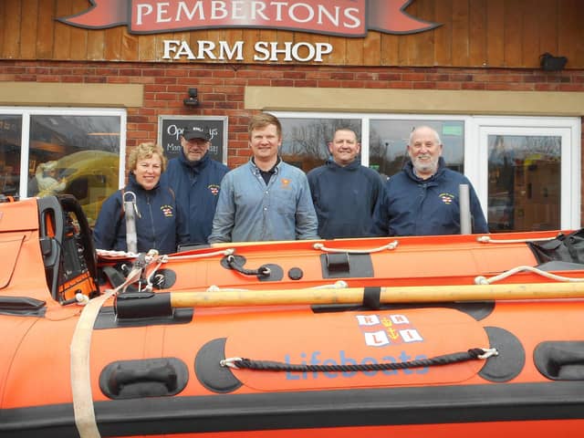 Tom Pemberton (centre) shapes up for Leg It For the Lifeboats with Lytham St Annes RNLI volunteers