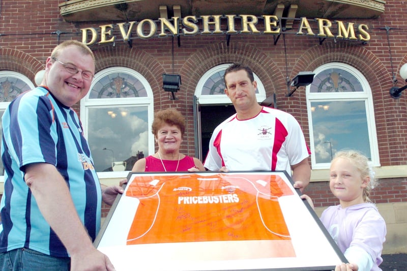 Landlady of the Devonshire Arms Patricia Walmsley, Mark Welch and Shola Welch at the presentation of a signed Blackpool FC shirt to David O'Neil in 2004