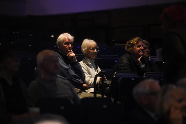 Members of he audience watch The Queen's funeral on the screen at Lowther Pavilion.