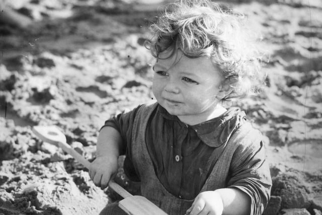 A little evacuee from the East End of London plays on the sands at Blackpool in Lancashire