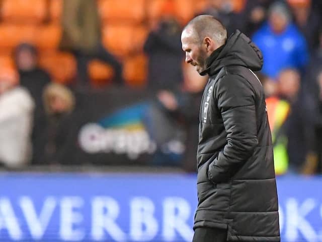 A downbeat Michael Appleton trudges onto the pitch at full-time