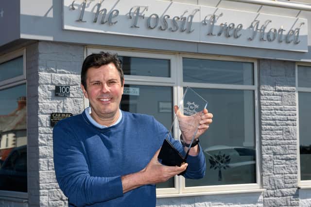 Owner of The Fossil Tree Hotel Chris Rinder with his award for Seaview Hotel of Year 2022.