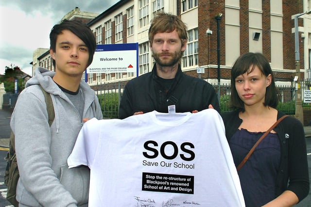 Photography students (from left) Nathan Walton, Ian Higginson and Helen Blacow, with a Tshirt signed by staff members, outside the Palatine Road campus of Blackpool and the Fylde College
