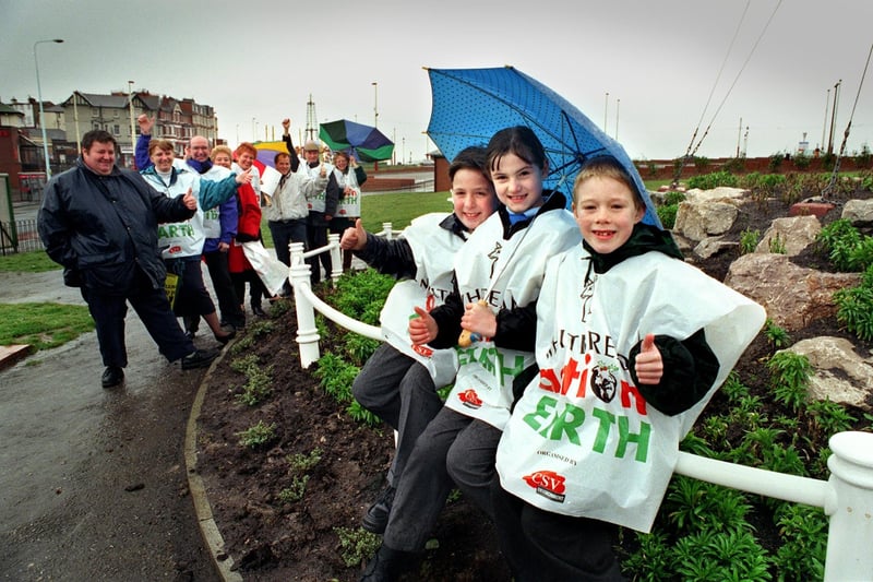 Holy Family RC Primary School pupils (from left), Antonio Artiano, Michaela Fish and Christopher Rogan - braving the bad weather, to show how proud they are of their school's efforts planting bulbs, shrubs and trees at the Flagstaff gardens in Gynn Square