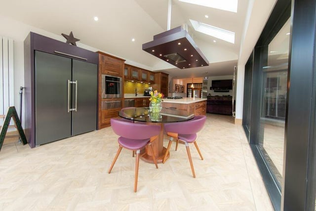 The stunning, bespoke fitted kitchen has quartz work surfaces. It also features a Wolf fan oven and warming drawer, Liebherr full height fridge and freezer, two Fisher Paykel dishwashers, recessed double sink with Quooker instant hot water tap, Mielle five burner gas hoband a glass breakfast table