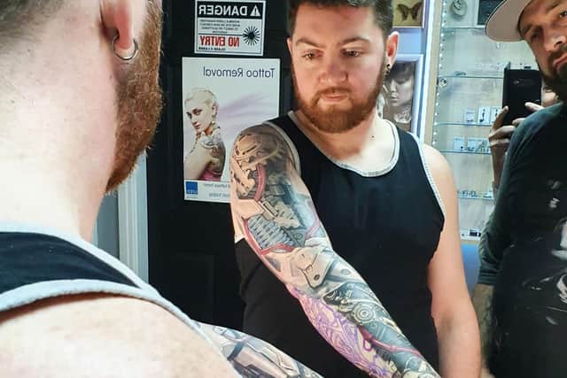 Paul, visiting from the United States, during tattoo session with Shamack.