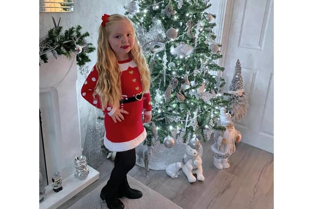 Ruby Bestford, aged 6, strikes a pose in her Santa outfit.