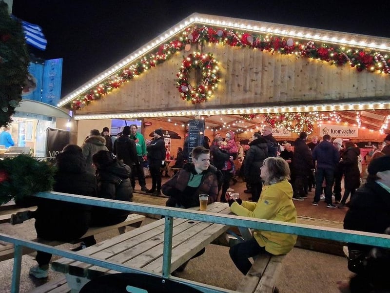 People enjoy a drink inside the cosy traditional German beer tent