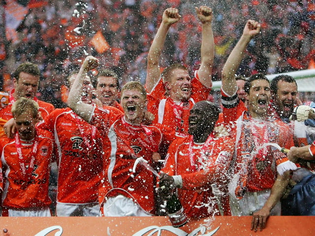 The Blackpool squad celebrate.