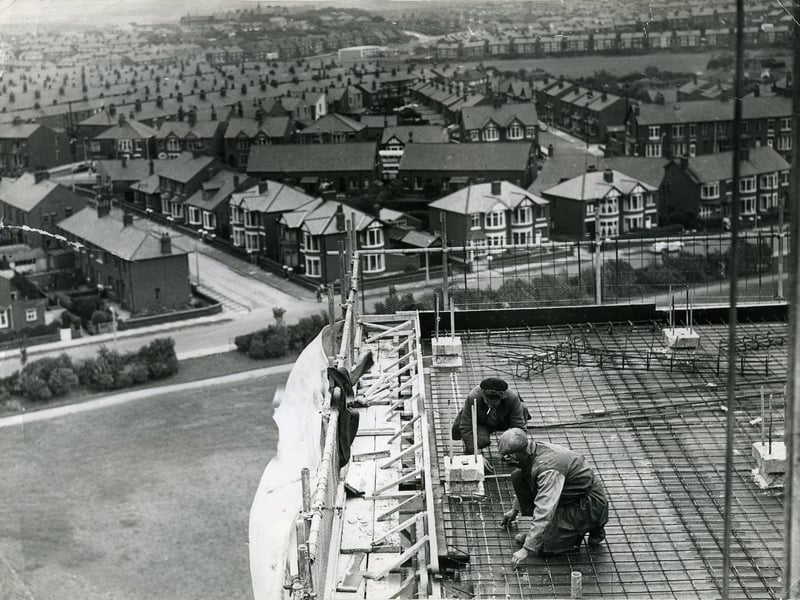Men working on the new high rise flats at Queenstown, Layton. Cumbrian Avenue joins Mather Street which runs left to right across the centre. The spire of Layton Hill Convent School (now St Mary's High School) can be seen in the distance to the left. The open ground of Kingscote playing fields can be seen top right