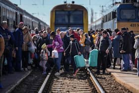 ZAHONY, HUNGARY - MARCH 12: People queue to board a train back to Ukraine across the border from Hungary on March 12, 2022 in Zahony, Hungary.  More than 2 million refugees have fled Ukraine since the start of Russia's military offensive, according to the UN. Hungary, one of Ukraine's neighbouring countries, has welcomed more than 144,000 refugees fleeing Ukraine after Russia began a large-scale attack. (Photo by Christopher Furlong/Getty Images)