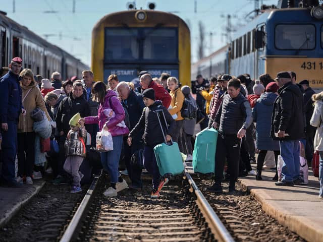 ZAHONY, HUNGARY - MARCH 12: People queue to board a train back to Ukraine across the border from Hungary on March 12, 2022 in Zahony, Hungary.  More than 2 million refugees have fled Ukraine since the start of Russia's military offensive, according to the UN. Hungary, one of Ukraine's neighbouring countries, has welcomed more than 144,000 refugees fleeing Ukraine after Russia began a large-scale attack. (Photo by Christopher Furlong/Getty Images)