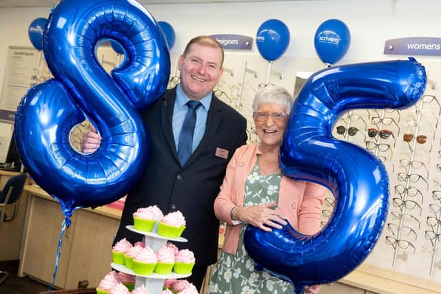 (L-R) Scrivens Poulton branch manager Paul Skelton celebrates the company's 85th anniversary with customer Ann Molloy who also celebrates her 85th birthday