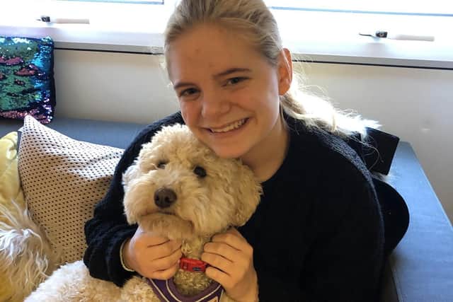 Tiffany Singer, 18, with Daisy the therapy dog at Park Community Academy