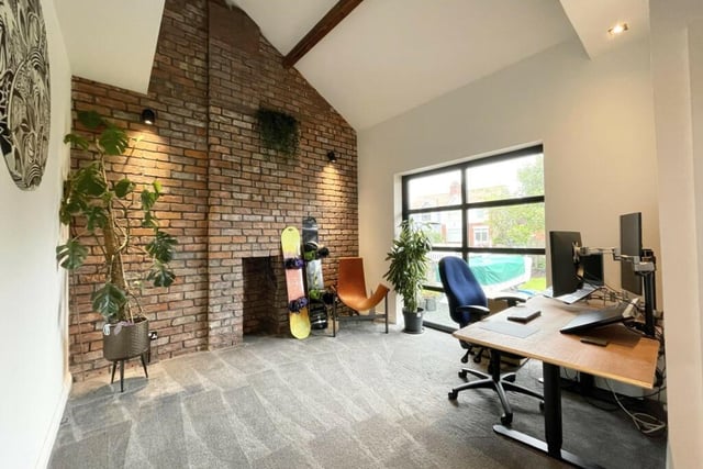 An impressive entrance leads to an office space with a vaulted ceiling