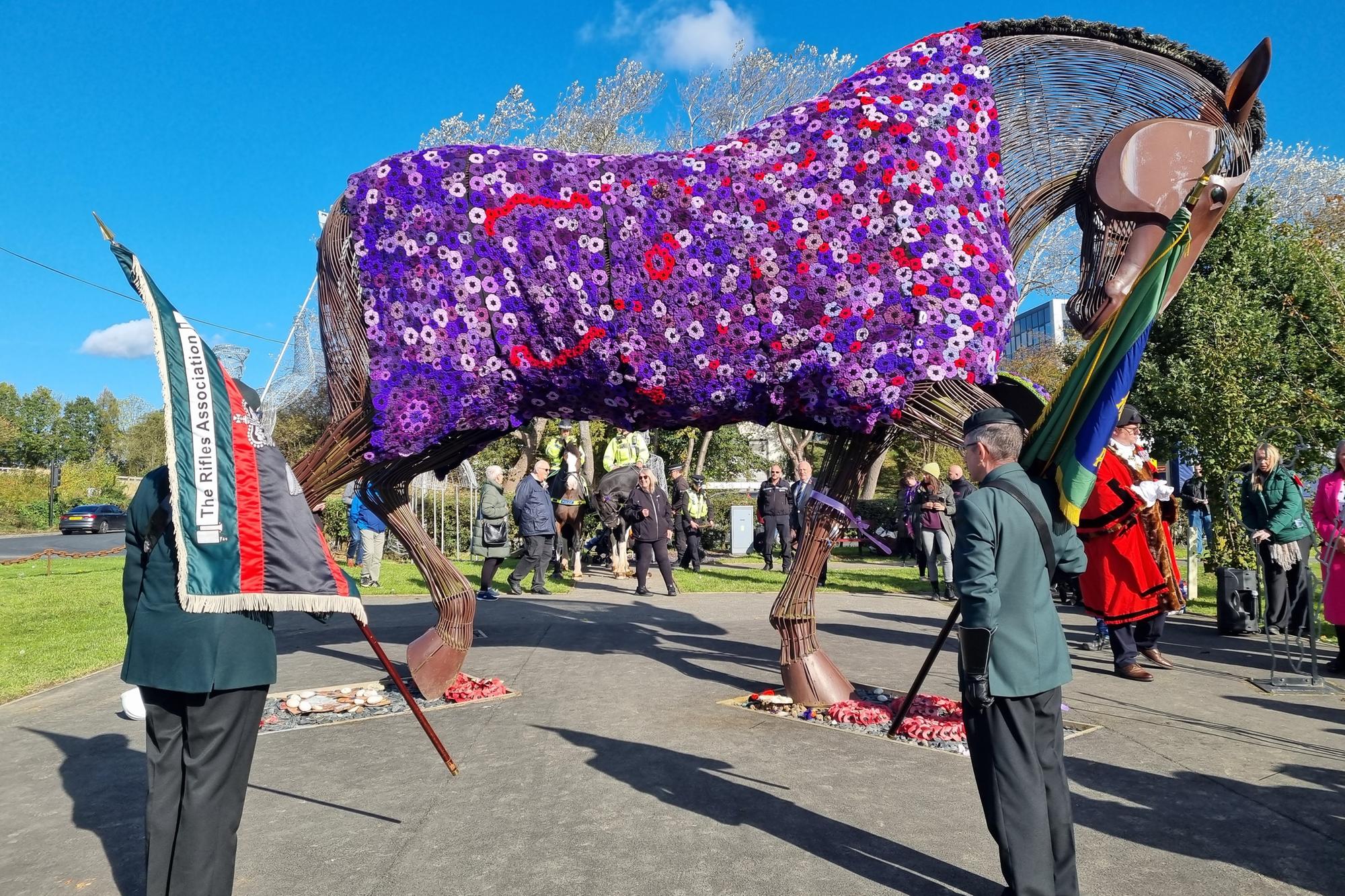 Purple poppy coat unveiled at War Horse memorial to commemorate service animals for remembrance day