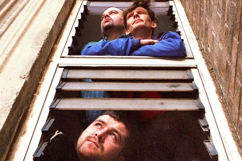 David Codona (left), Hamish MacNicol (right) and Mark Triplett in the broken windows of Churchill Court flats at Layton