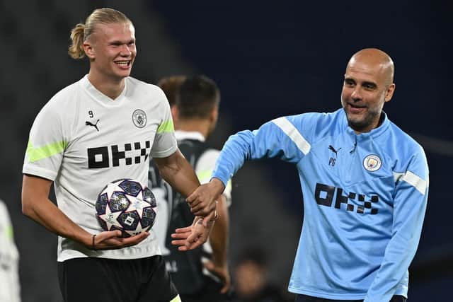 Manchester City's Spanish manager Pep Guardiola (R) speaks with Manchester City's Norwegian striker Erling Haaland during a training session at the Ataturk Olympic Stadium in Istanbul on June 9, 2023, on the eve of the UEFA Champions League final against Inter Milan. (Photo by Paul ELLIS / AFP) (Photo by PAUL ELLIS/AFP via Getty Images)