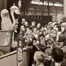 A wave from Father Christmas as he leaves North Station in a Rolls Royce for the Co-op Lancastria Toyr Fair in 1972