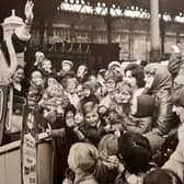 A wave from Father Christmas as he leaves North Station in a Rolls Royce for the Co-op Lancastria Toyr Fair in 1972