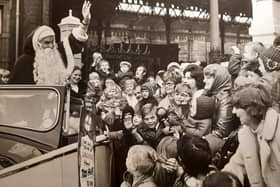 A wave from Father Christmas as he leaves North Station in a Rolls Royce for the Co-op Lancastria Toyr Fair in 1972