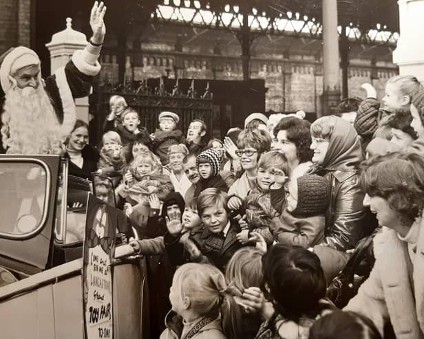 A wave from Father Christmas as he leaves North Station in a Rolls Royce for the Co-op Lancastria Toyr Fair in 1972