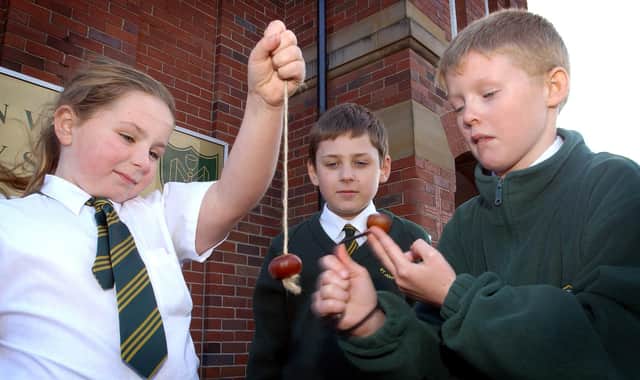 Pupils of St John Vianney School in Blackpool playing a traditional game of conkers in the playground. L-R are Shelby Cathie (10), Harry Daniels (9) and Adam Weighman (10)
