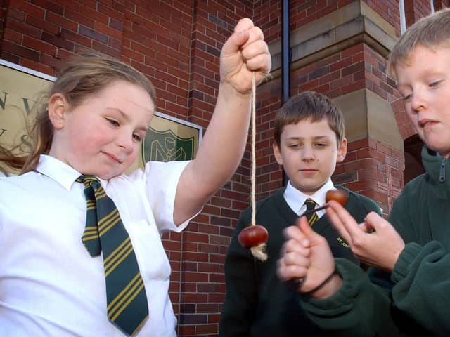 Pupils of St John Vianney School in Blackpool playing a traditional game of conkers in the playground. L-R are Shelby Cathie (10), Harry Daniels (9) and Adam Weighman (10)