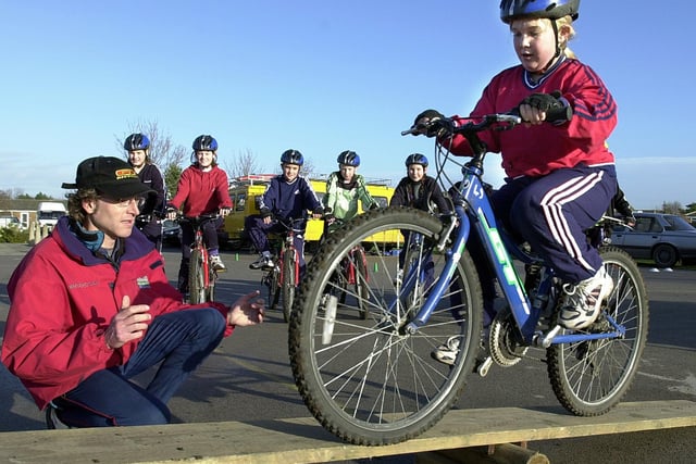 Lancashire Education Outdoor Road Show at Lytham Hall Park Primary School. Instructor Nigel Cole watches 11-year-old Charlotte Lewis negotiate the see-saw on his bike