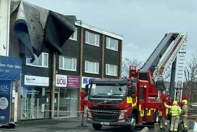 Fire crews used the aerial ladder platform to remove the loose felt roofing from the three-storey building. Picture by Jay Taylor