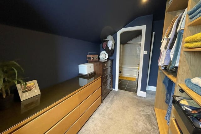 The walk-in dressing room is spacious with lots of storage