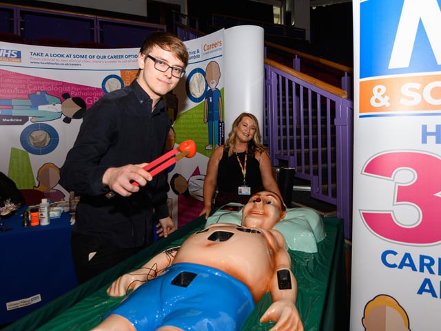 Luke Fiztgerald with Karen Gore from Lancashire Teaching Hospitals trys out a lifesize operation game at Lancashire Business Expo 2022. Photo: Kelvin Stuttard