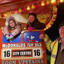 Poulton Rotary Bonfire chairman Roger Critchley flags down the city bus passengers Jessica Flitcroft and Ellie Williams, from Carleton