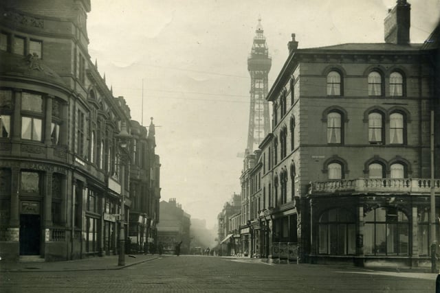 This is Market Street. The Clifton Hotel is on the right and beyond the man (with what appears to be a plank across his back ) there is a stall on the corner of the old St John's Market. On the left is the Williams Deacons Bank which is now part of the Town Hall