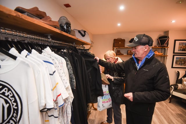 Customers take a look at what's on show at Attire by Trinity Hospice charity menswear shop in Lytham