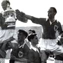 Harry Johnston and Stanley Matthews are carried shoulder high with the FA Cup