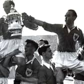 Harry Johnston and Stanley Matthews are carried shoulder high with the FA Cup