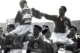 Harry Johnston and Stanley Matthews are carried shoulder high with the FA Cup