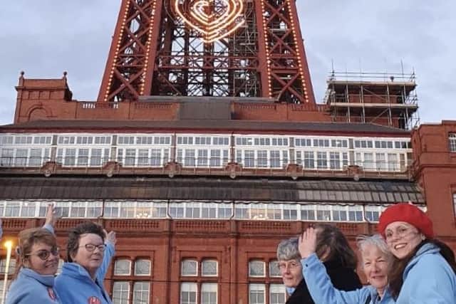 Members of Soroptimist International of Blackpool and District in front of the Tower lit up orange to raise awareness of violence against women