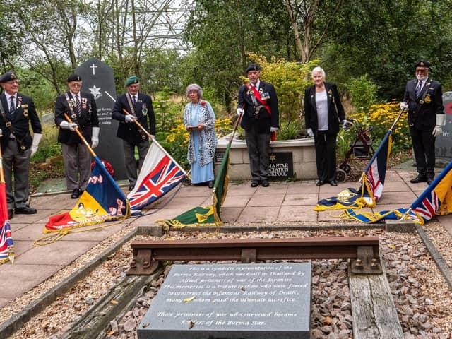 Standards are lowered poignantly towards a replica piece of track from the Burma Star Railway, built by Far East prisoners of war at the Fylde Coast Memorial Arboretum for the VJ Day ceremony