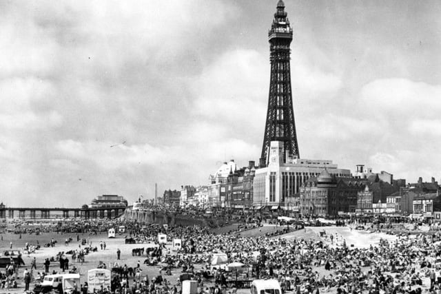 Crowds of holiday-makers on the beach at Blackpool, Lancashire, dominated by the Blackpool Tower on July 18, 1951