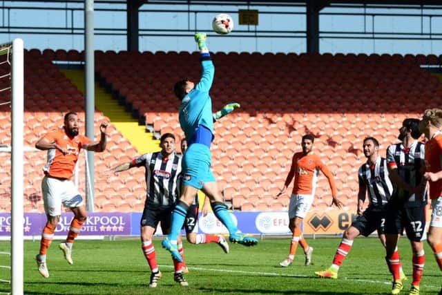 Grimsby goalkeeper James McKeown punches clear against Blackpool