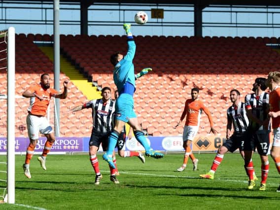 Grimsby goalkeeper James McKeown punches clear against Blackpool