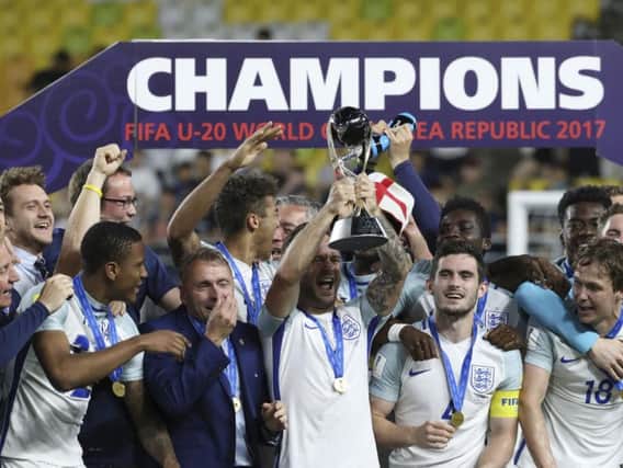 Paul Simpson and his England's players celebrate on the podium after defeating Venezuela during the final match of the FIFA U-20 World Cup Korea 2017 at Suwon World Cup Stadium in Suwon, South Korea